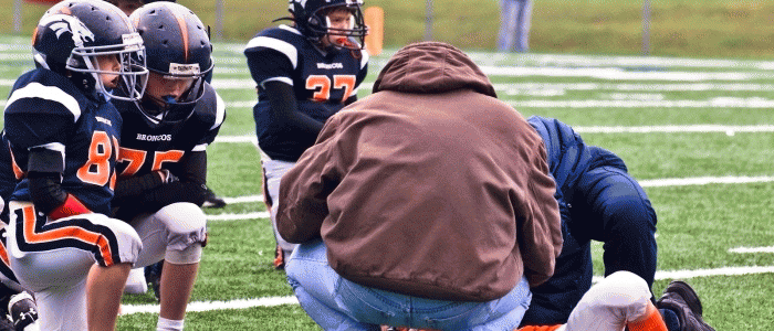 Youth football player with head injury during game